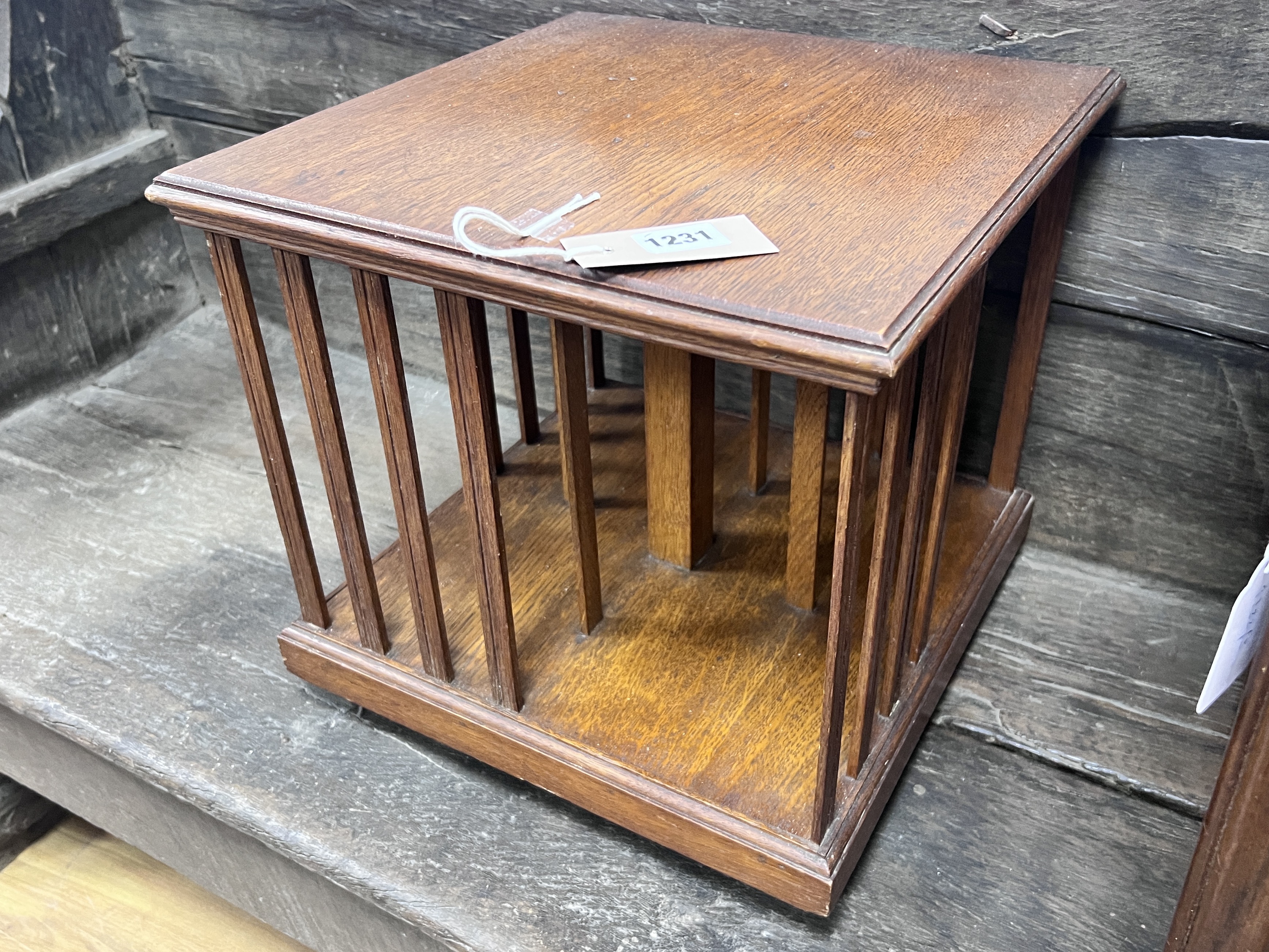 An Edwardian oak table top revolving bookcase, width 33cm, height 32cm